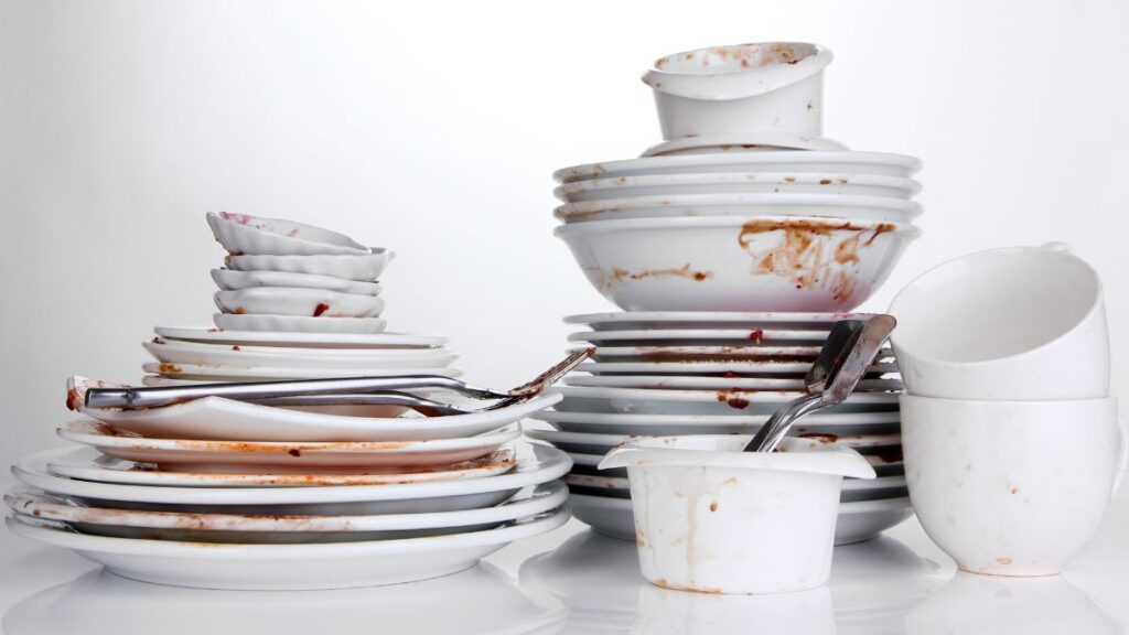 Stack of white dishes with food on them