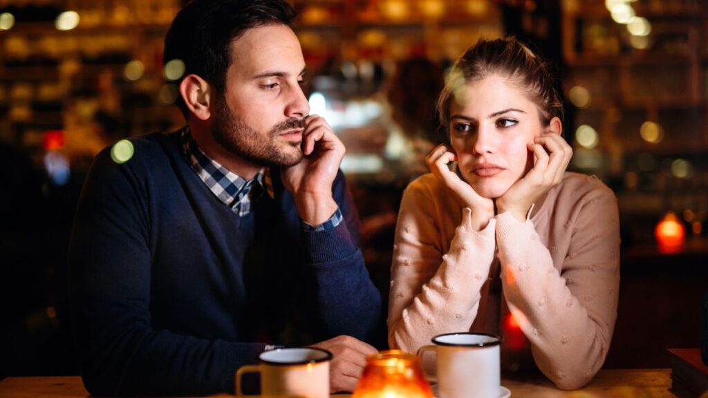 Sad couple at a table in a restaurant