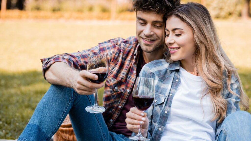 couple sitting together with wine outside