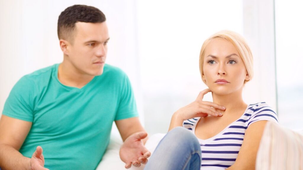 couple not communicating and looking upset on the couch