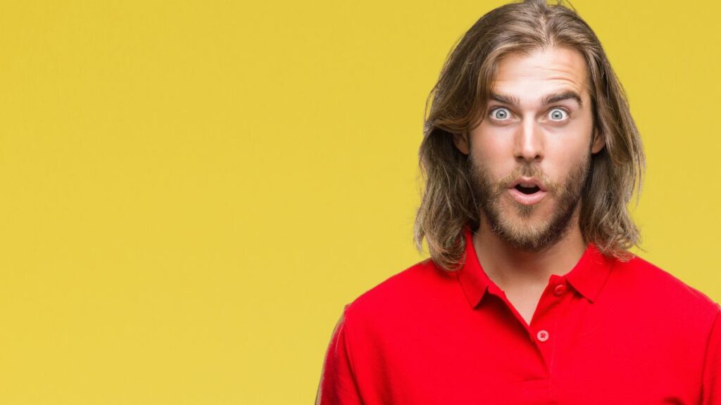 man looking surprised in a red shirt