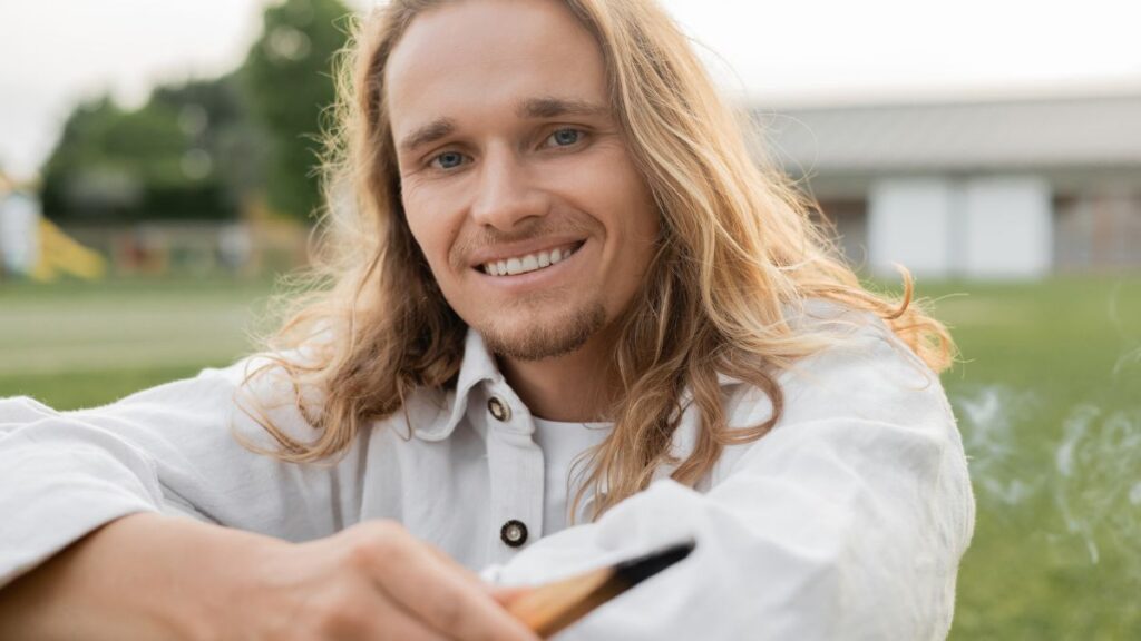 man smiling with long hair