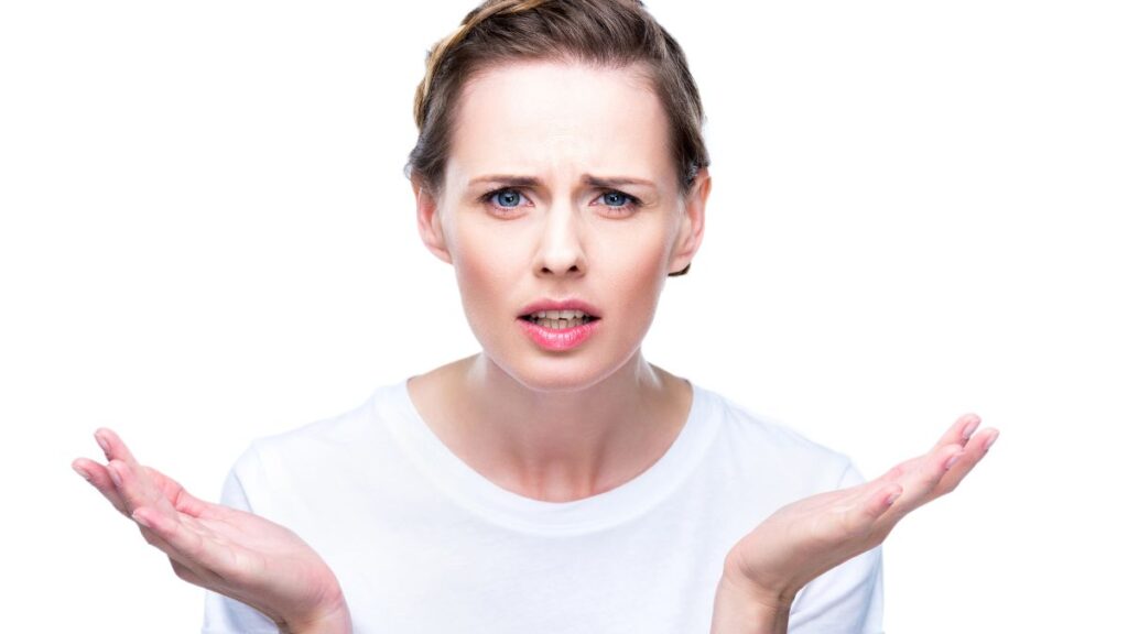 woman looking confused with hands up