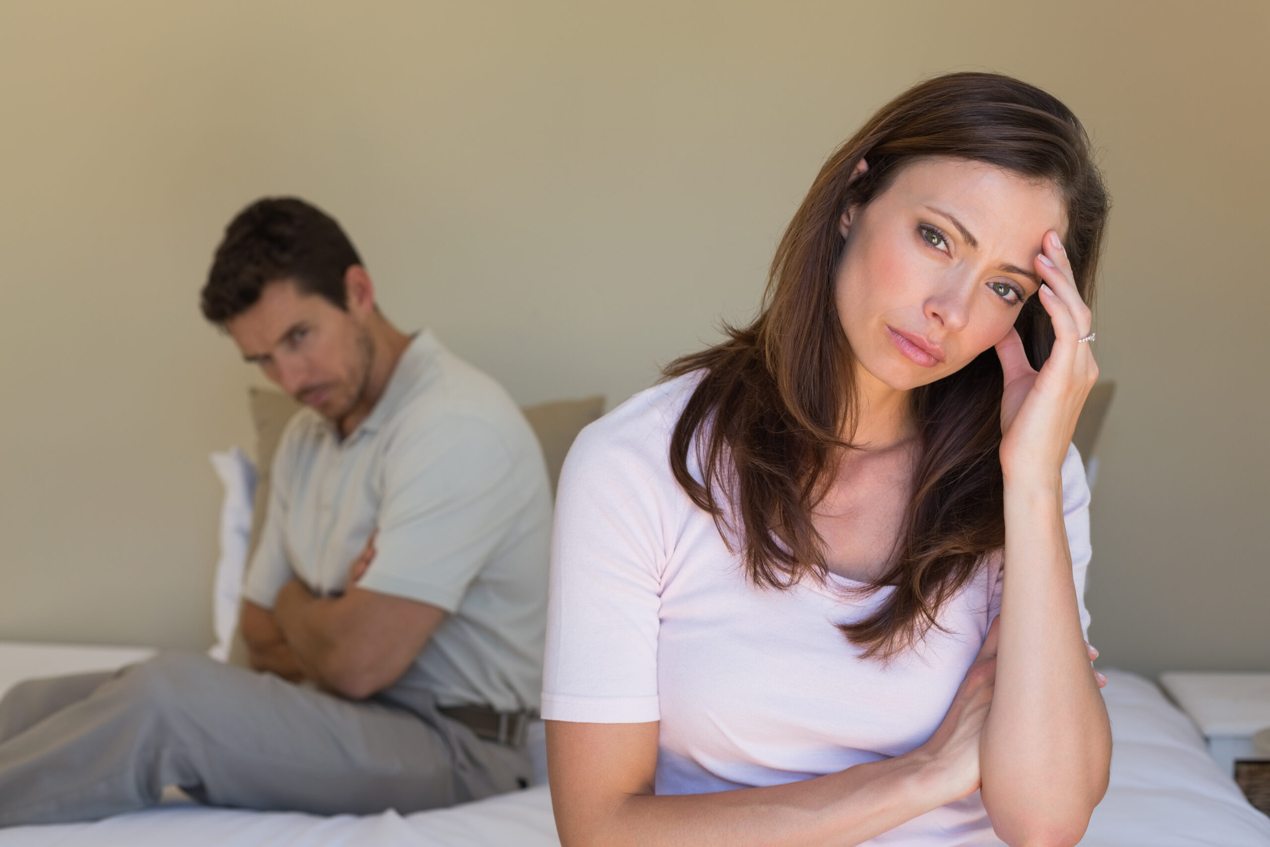 Unhappy couple not talking after an argument in bed at home