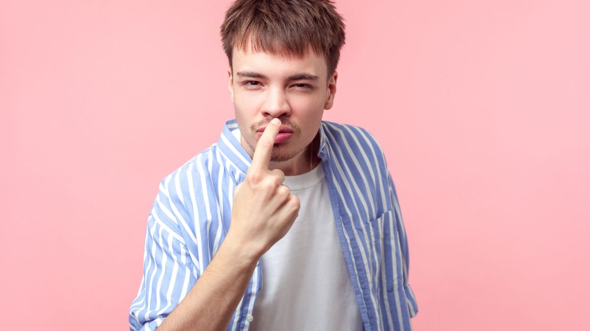 man looking serious pointing to his face