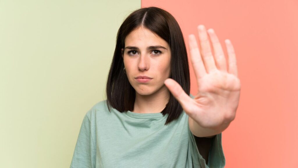 woman with hand up confidently showing stop