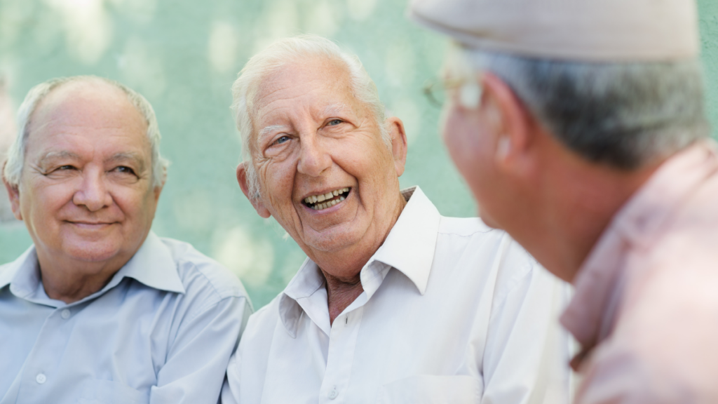 Three older men laughing