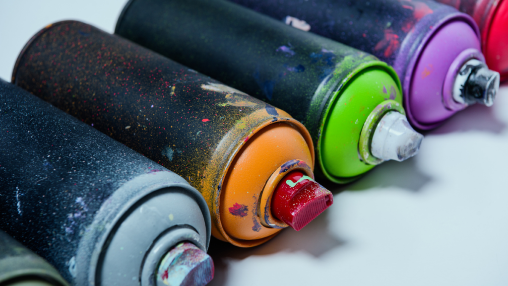 Row oc spray paint cans of different colors