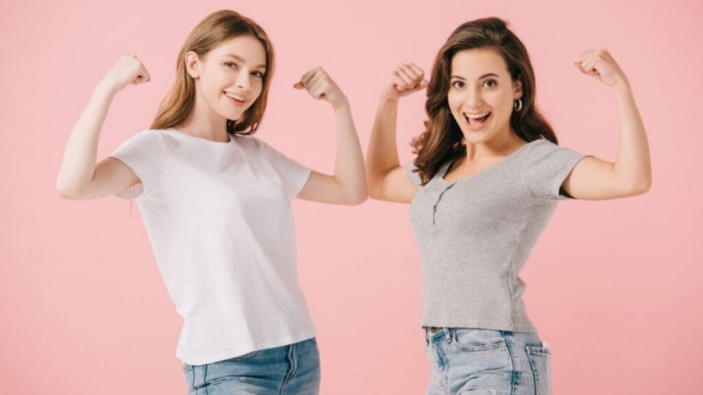 Two women showing their muscles 
